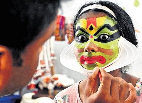 A kathakali artist getting her make-up done at the revenue district school arts festival at Neyyattinkara in Thiruvananthapuram on Monday 