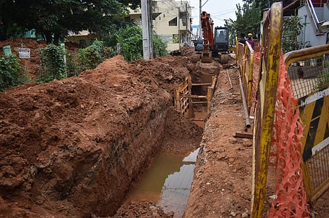 UGD workers pumping out over flowing ground water with motors into storm water drain at Min nagar near Kuniyamuthur in Coimbatore