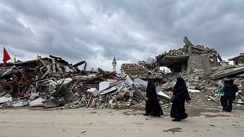 Residents walk past destroyed buildings as they return to Nabatiyeh, southern Lebanon, Thursday, Nov. 28, 2024 following a ceasefire between Israel and Hezbollah that went into effect on Wednesday.