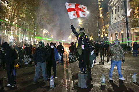 Demonstrators participate a rally to protest against the government's decision to suspend negotiations on joining the European Union in Tbilisi, Georgia, early Wednesday, Dec. 4, 2024. 