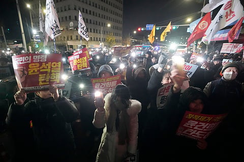 People gather to demand South Korean President Yoon Suk Yeol to step down in front of the National Assembly in Seoul, South Korea, Wednesday, Dec. 4, 2024. 