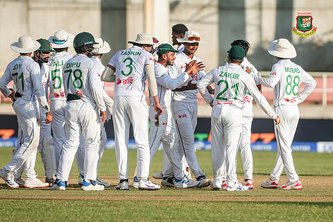Bangladesh players celebrate after taking a wicket 