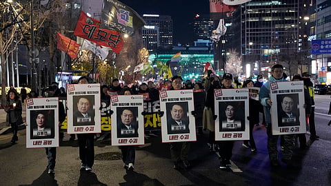 Protesters march to the presidential office after a candlelight vigil against South Korean President Yoon Suk Yeol in Seoul, South Korea, Thursday, Dec. 5, 2024. 