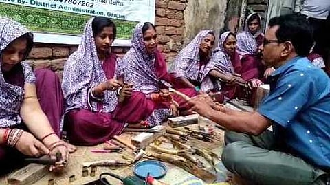 Women learning brass fish art 