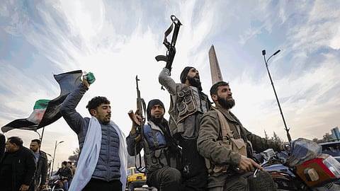 Rebels and Syrian civilians celebrate the fall of the government in Damascus as President Bashar al-Assad flees the country, Dec. 8, 2024.
