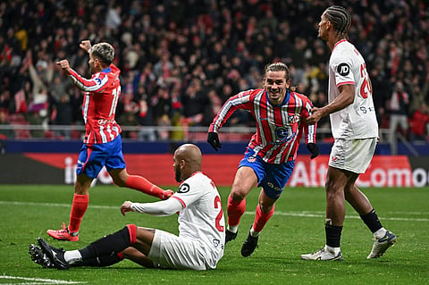 Atletico Madrid's French forward #07 Antoine Griezmann (2R) celebrates scoring their fourth goal during the Spanish league football match between Club Atletico de Madrid and Sevilla FC at the Metropolitano stadium in Madrid on December 8, 2024. 