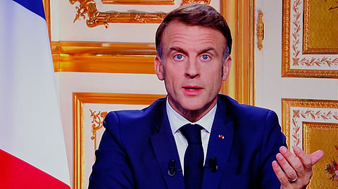 French President Emmanuel Macron is seen on monitors in a control room at AFP headquarters as he addresses the nation during a televised broadcast from the presidential Elysee Palace on the day of the Prime Minister's resignation on December 5, 2024.