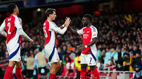 Arsenal's Bukayo Saka, right, celebrates with teammates after scoring his side's second goal during the Champions League opening phase football match between Arsenal and Monaco, at the Emirates Stadium in London.