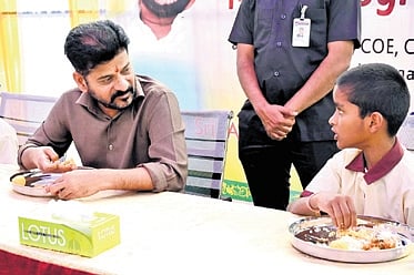 Chief Minister A Revanth Reddy and Deputy Chief Minister Mallu Bhatti Vikramarka share a  meal with students of government-run educational institutions at Chilkur and Bonkal respectively as part of the launch of the uniform diet menu on Saturday. 