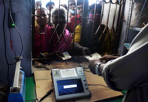 A staff working with Point of Sale Machine (PoS) in ration shop in Coimbatore; Representational image