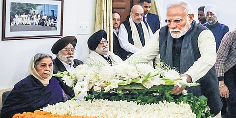 Prime Minister Narendra Modi pays his last respects to former prime minister Manmohan Singh, in New Delhi  on Friday | PTI