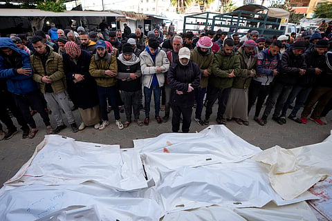 Palestinians attend funeral prayers over the bodies of those killed in overnight Israeli airstrikes on the Maghazi refugee camp, at Al-Aqsa Hospital, in Deir al-Balah, central Gaza Strip, Saturday, Dec. 28, 2024. 