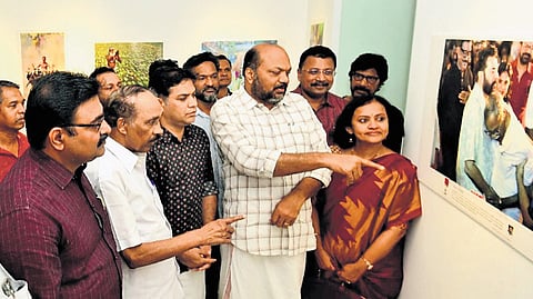 Industries Minister P Rajeeve, councillor Padmaja S Menon, KSFE MD S K Sanil, MP Hibi Eden, MLAs K Babu and T J Vinod, and Mayor M Anilkumar view the photographs on display at ‘Portfolio 2025’ organised by the Kochi Photojournalists Forum at Durbar Hall Art Gallery on 
Sunday.