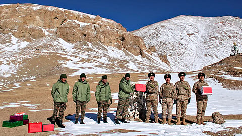 Indian and Chinese soldiers exchange sweets along the LAC in Ladakh during Diwali, Thursday, Oct. 31, 2024, after ending a four-and-a-half-year border standoff.