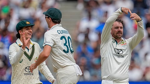 Australia's captain Pat Cummins, center, Travis Head, left, and Sam Konstas celebrates the wicket of India's Rishabh Pant during play on the last day of the fourth cricket test between Australia and India