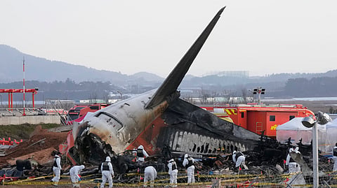 Rescue team members work at the site of a plane crash at Muan International Airport in Muan, South Korea, Tuesday, Dec. 31, 2024.