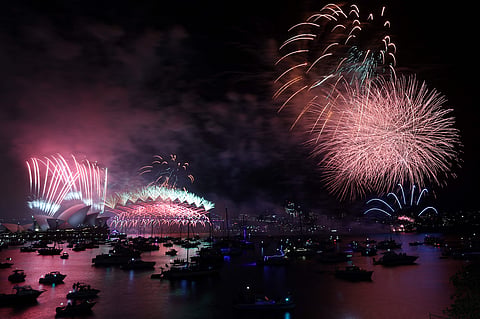 Fireworks light up the sky over Sydney Harbour Bridge and Sydney Opera House.