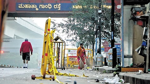 Pourakarmikas clear waste from Mahatma Gandhi Road-Brigade Road Junction on Wednesday morning 