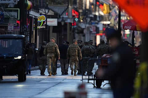 Military personnel walk down Bourbon street, Thursday, Jan. 2, 2025 in New Orleans.