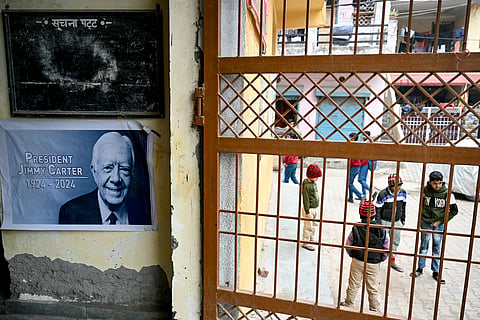 A poster in the memory of late former US president Jimmy Carter, is displayed at a community center in the eponymous Carterpuri village of Gurgaon on January 7, 2025.
