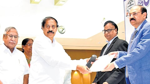 CPI State secretary K Ramakrishna submits a representation to the APERC at the public hearing in Vijayawada on Wednesday  