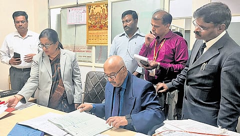 Upa Lokayukta Justice KN Phaneendra checks records at the office of the Executive Engineer of BBMP in Malleswaram during his surprise visit on Friday