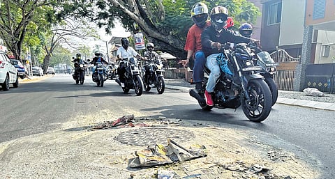 Motorists passing through the P V Antony Road that has protruding manholes constructed at the centre of the road 