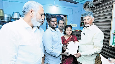 Chief Minister N Chandrababu Naidu with a household after inaugurating the Piped Natural Gas (PNG) connections in Tirupati on Sunday