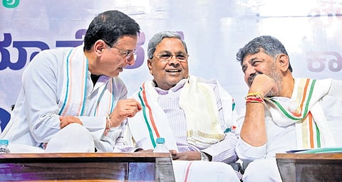 AICC general secretary Randeep Singh Surjewala shares a light moment with  Chief Minister Siddaramaiah and Deputy Chief Minister DK Shivakumar during a meeting at Bharat Jodo Bhavan in Bengaluru on Monday 