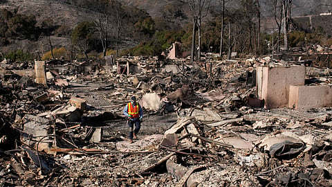 A worker surveys the damage from the Palisades Fire in the Pacific Palisades neighbourhood of Los Angeles, Monday, Jan. 13, 2025.