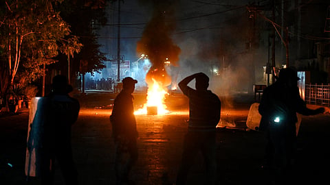 In this photo from Dec. 31, 2024, police personnel (front) disperse Shiite Muslim protesters during a demonstration to condemn sectarian clashes in Pakistan's Kurram district, bordering Afghanistan.