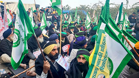 Farmers wear black clothes during their protest at the Khanauri border seeking a legal guarantee on the minimum support price (MSP) for crops, in Sangrur district on January 15,