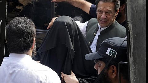 Pakistan’s former Prime Minister Imran Khan, right, with his wife Bushra Bibi. 