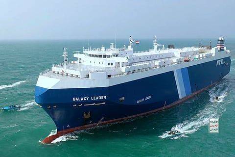 This photo released by the Houthi Media Center shows Houthi escort the cargo ship Galaxy Leader in the Red Sea off the coast of Yemen, Nov. 19, 2023