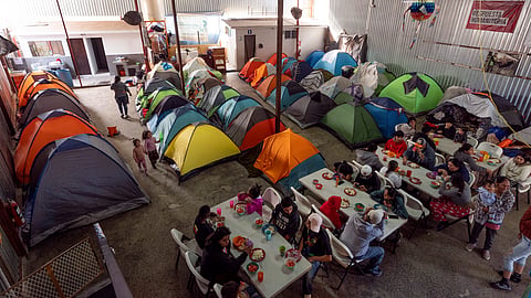 Migrants eat at a shelter Wednesday, Jan. 22, 2025, in the border city of Tijuana, Mexico.