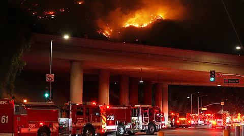 Apparatus sits on Sepulveda Blvd. as fire burns along Interstate 405, Thursday, Jan. 23, 2025, in Los Angeles.