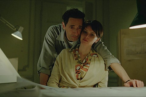 This image released by A24 shows Adrien Brody, left, and Felicity Jones in a scene from "The Brutalist." 