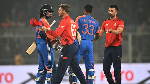 England's captain Jos Buttler (2L) with his teammate congratulates India's Tilak Varma (L) and Hardik Pandya (2R) for their team's win at the end of their first Twenty20 international cricket match in the Eden Gardens of Kolkata on January 22, 2025. 