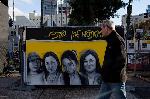 A mural of female Israeli soldiers held hostage by the Hamas militant group in the Gaza Strip is displayed in Tel Aviv, Israel, Friday, Jan. 24, 2025. 