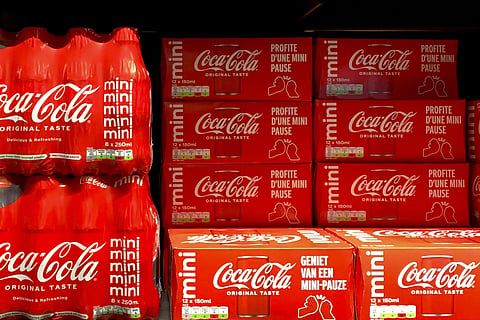 Cleared cases of soft drinks sit on a shelf in a supermarket in Antwerp, Belgium, after Coca-Cola recalled some of its soft drinks in Europe, Tuesday, Jan 28, 2025.