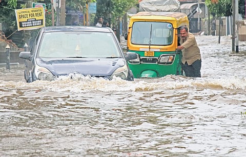 Motorist caught up in the flooded city roads  as unexpected rain lashed the city last year