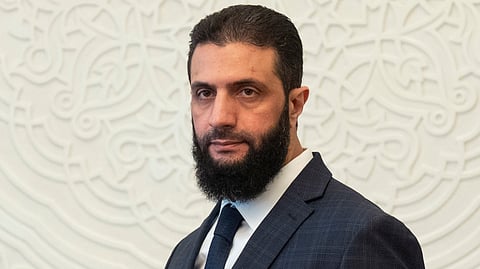 Syria's de facto leader Ahmad al-Sharaa, formerly known as Abu Mohammed al-Golani, walks in the presidential palace ahead of his meeting with Walid Ellafi, Libyan minister of state for communication and political affairs, in Damascus, Dec. 28, 2024.