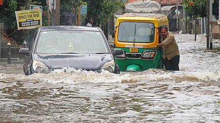 Motorist caught up in the flooded Kallummoodu road due to heavy rain 