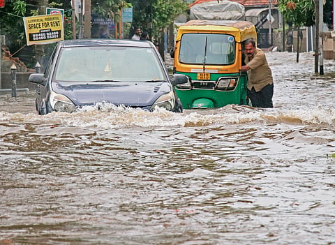 Motorist caught up in the flooded city roads  as unexpected rain lashed the city last year