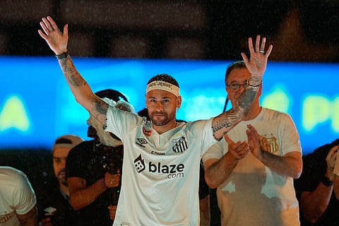 Brazilian soccer player Neymar waves to fans during his presentation ceremony after signing a six-month contract with Santos FC at Vila Belmiro Stadium in Santos, Brazil, Friday, Jan. 31, 2025. 