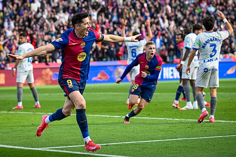 Barcelona's Polish forward #09 Robert Lewandowski (L) celebrates after scoring their first goal during the Spanish league football match between FC Barcelona and Deportivo Alaves at the Estadi Olimpic Lluis Companys in Barcelona on February 2, 2025. 