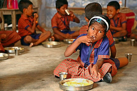 A school kid having her noon meal.