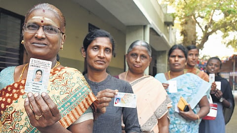 People line up to exercise their franchise at the Railway Colony polling booth in Erode on Wednesday