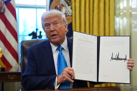 President Donald Trump holds an executive order regarding withdrawing from the United Nationals Human Rights Council in the Oval Office of the White House, Tuesday, Feb. 4, 2025, in Washington. 