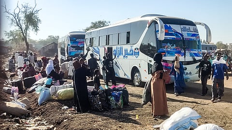 People displaced by the ongoing war in Sudan prepare to board buses taking them home to their city of Wad Madani in the Jazira state after it was retaken by the Sudanese army from the Rapid Support Forces (RSF) paramilitaries, in the eastern city of Gedaref on February 3, 2025. 